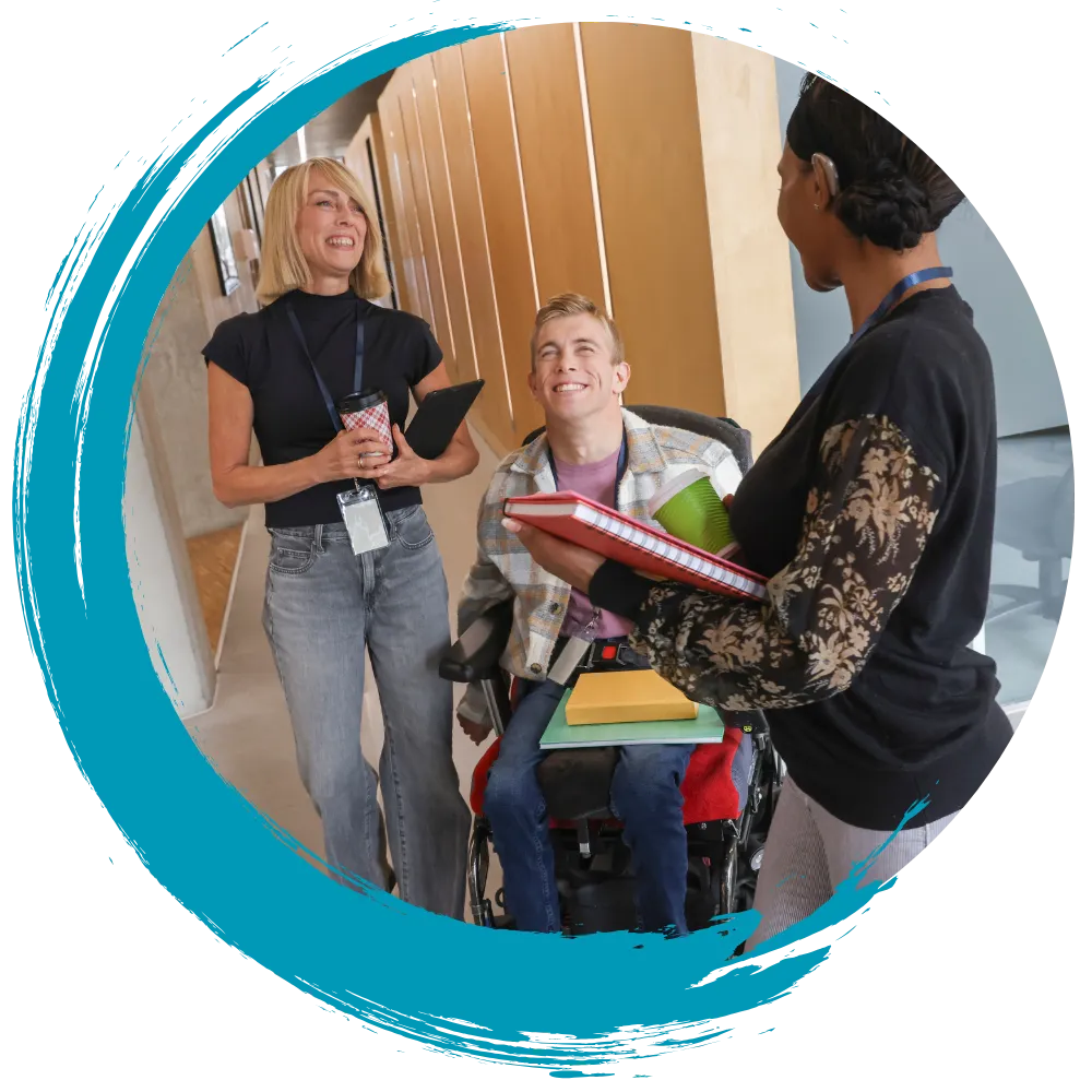 Support worker smiling with two NDIS participants