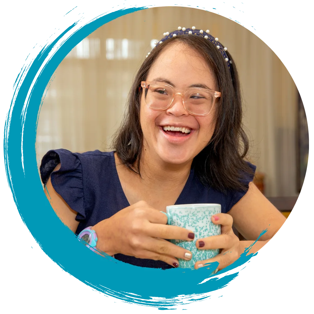 Disabled woman holding cup of tea smiling